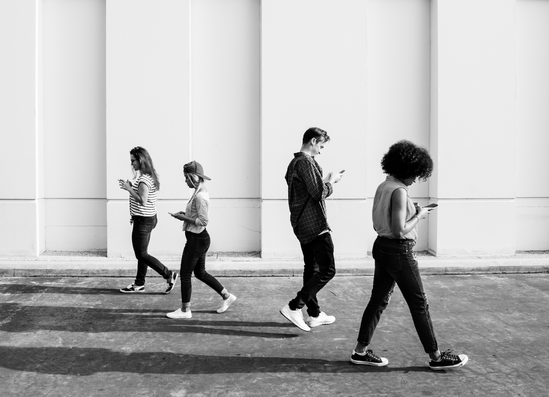young-adults-using-smartphones-as-they-are-walking-outdoors